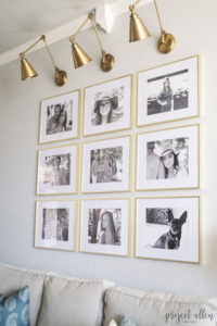 Creating a Grid Style Gallery Wall with these easy tips and tricks. Brass matted picture frames, brass swing arm sconces turned into a gallery wall creates the perfect backdrop for our sofa.