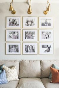 Creating a Grid Style Gallery Wall with these easy tips and tricks. Brass matted picture frames, brass swing arm sconces turned into a gallery wall creates the perfect backdrop for our sofa.