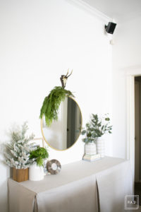 A snowy flocked Christmas tree decorated in red, green and gold gives a big dose of nostalgia to this modern farmhouse living room. 