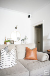 breath of fresh air spring home tour: neutral modern farmhouse/California cool living room with pops of warm leather and blue.