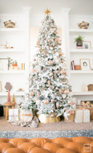 Learn how to decorate a Christmas tree like a pro. This a flocked Christmas tree decorated with black and white ribbon. With gorgeous blush, copper, bronze and gold ornaments.